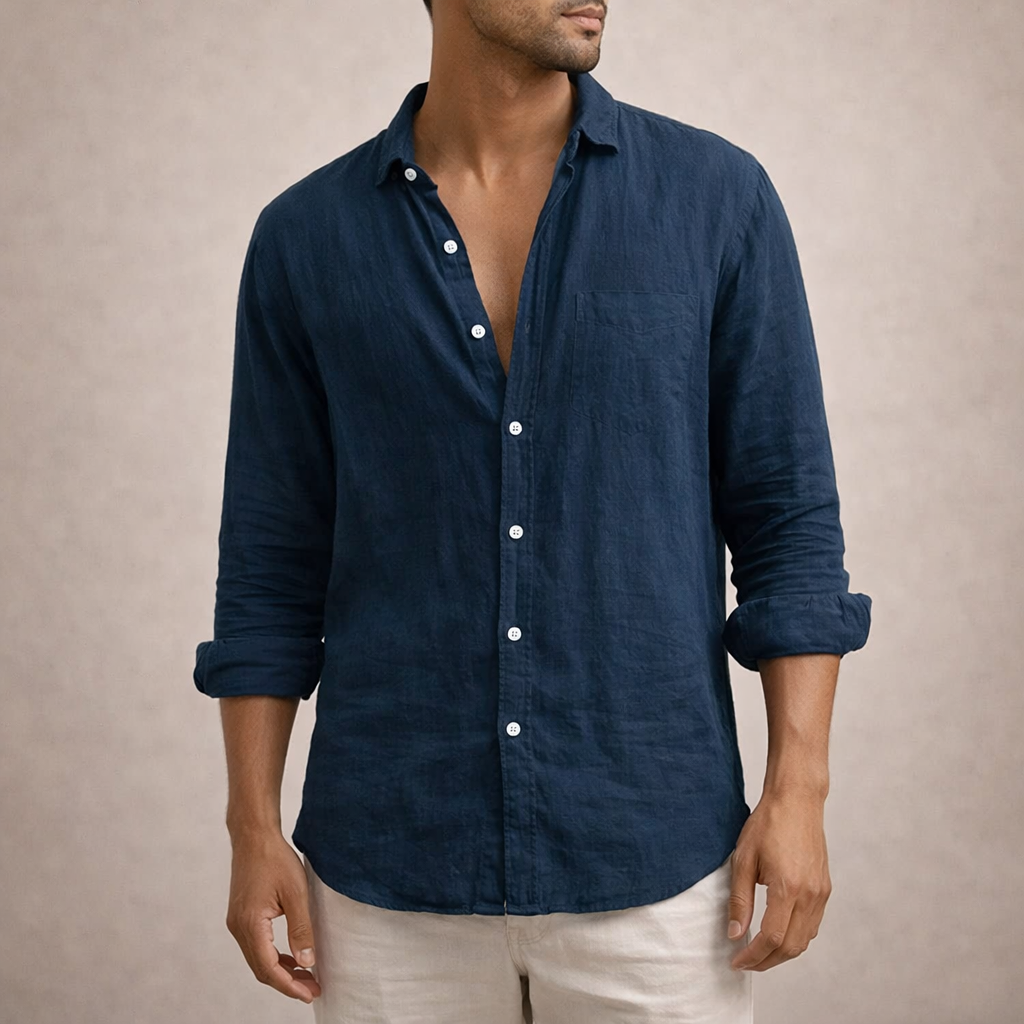 Model in marineblauw linnen overhemd met borstzak en opgerolde mouwen, gecombineerd met een crèmekleurige broek. 7