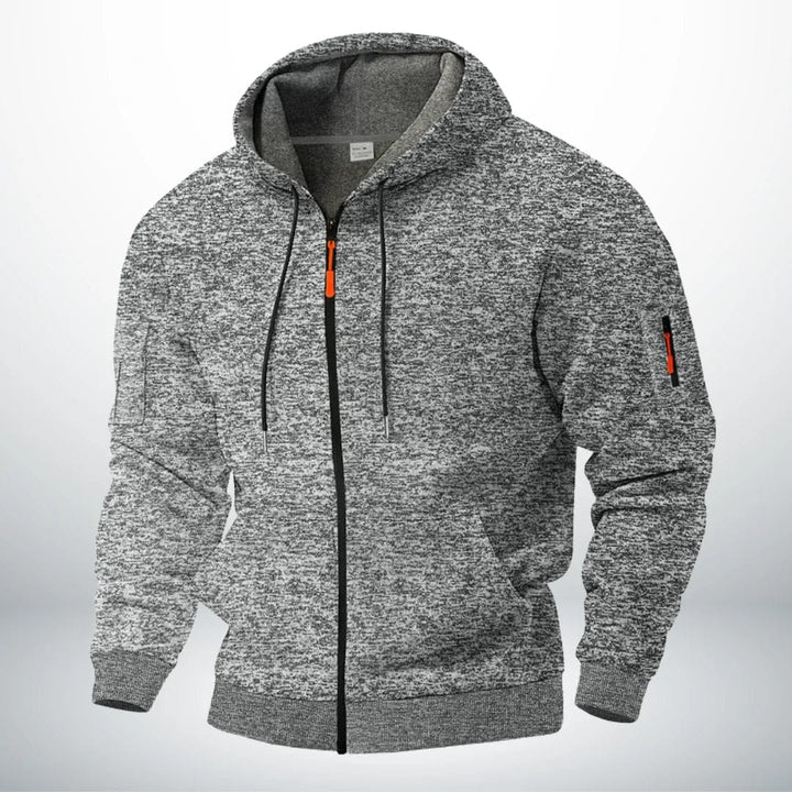 Hoodie in gemêleerd lichtgrijs met grijze binnenvoering, voorzien van capuchon, koordjes, voorzakken en een rits op de mouw. 3