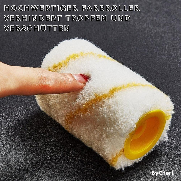 Close-up van een losse ronde verfrol met witte pluizige stof en gele strepen, met een vinger die erin drukt. 7