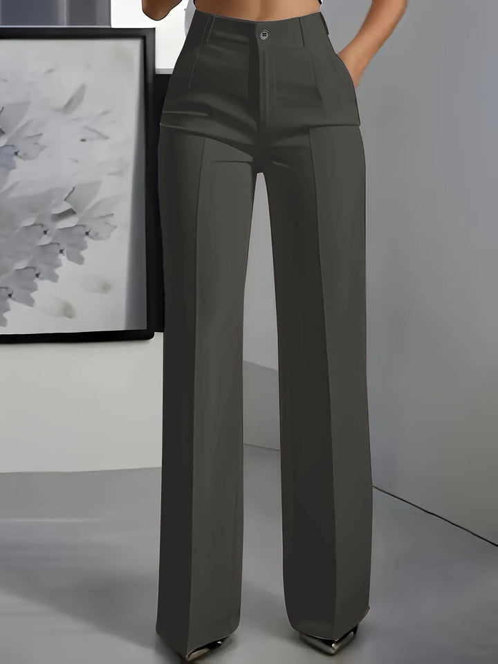 Voorkant van een donkergrijze broek met hoge taille en wijde pijpen, gedragen door een model 3