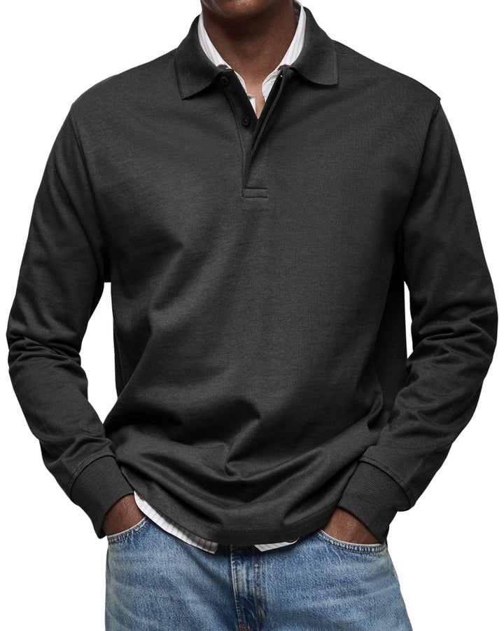 Voorkant in zwart: model draagt het shirt met ribboorden over een wit gestreept overhemd en een spijkerbroek. 4