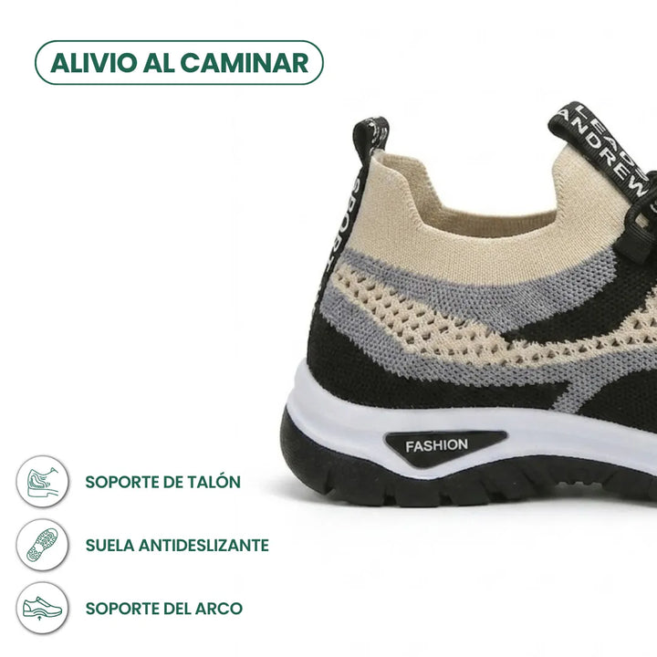 Achterkant van de beige sneaker met zwarte en grijze mesh en zwarte antislipzool, met iconen voor hiel- en boogondersteuning. 40
