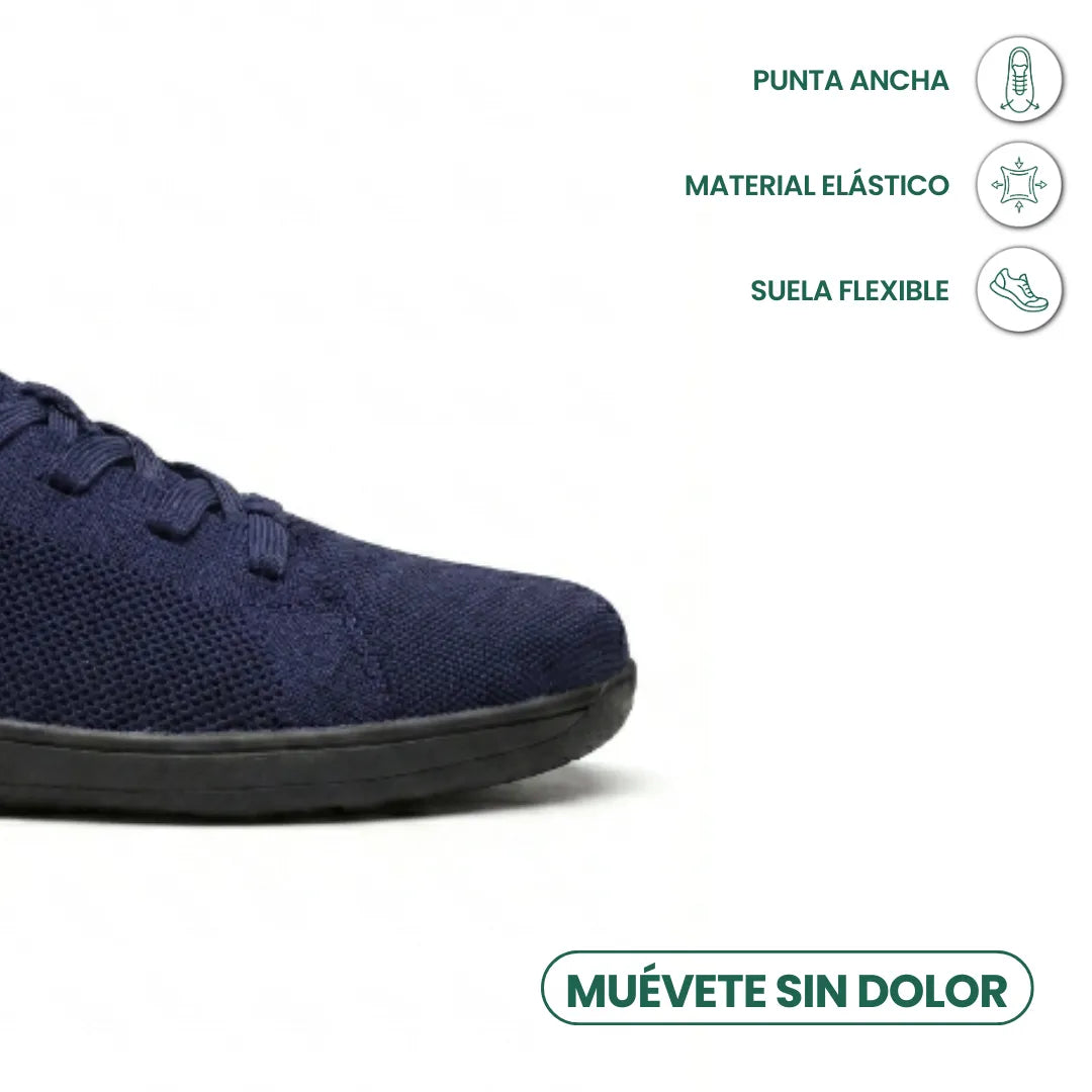 Close-up van de brede neus van de marineblauwe sneaker met zwarte zool, met pictogrammen voor flexibele zool en elastisch materiaal. 23