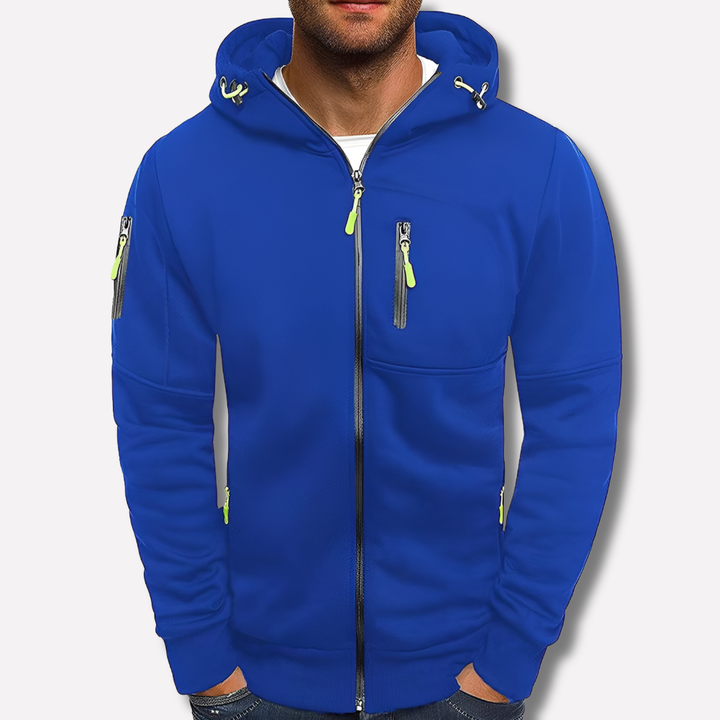 Kobaltblauwe hoodie met rits en neongroene ritstrekkers, voorkant gedragen door een model, tegen een neutrale lichte achtergrond. 2