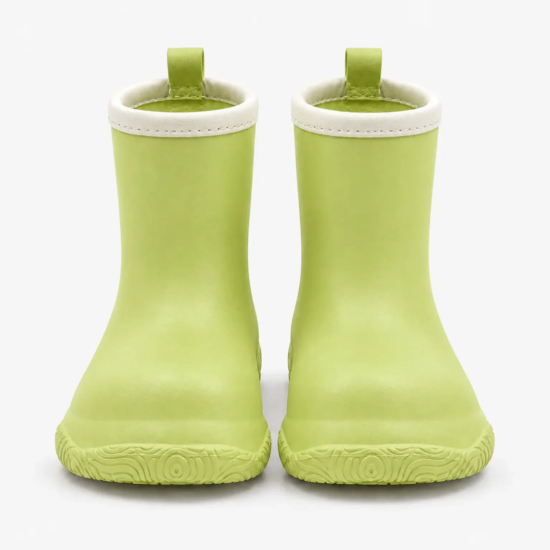 Groene laarsjes van voren gezien op een witte achtergrond, met crèmekleurige rand, trekkus en gegolfd profiel onder de neus. 7