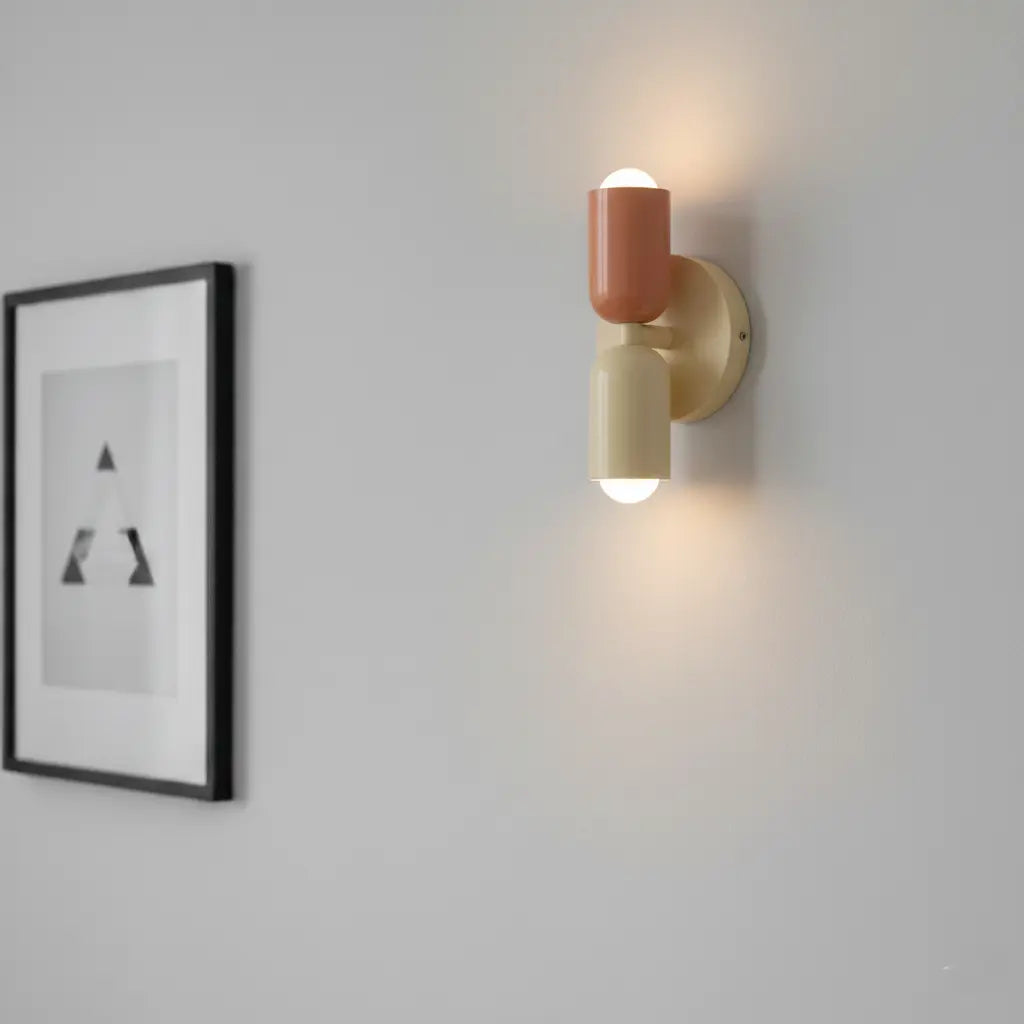 Lamp in terracotta en crème brandt op een lichtgrijze muur, met links een ingelijste zwart-witprint van driehoeken. 4