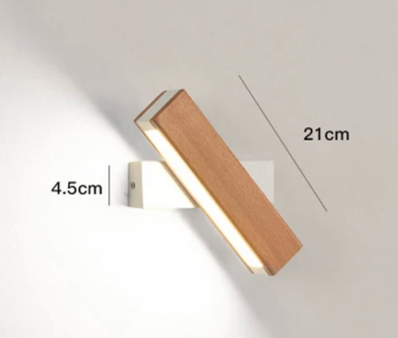 Houten wandlamp met witte bevestiging, schuin gedraaid, met maataanduidingen voor de lengte en de hoogte van de bevestiging. 4