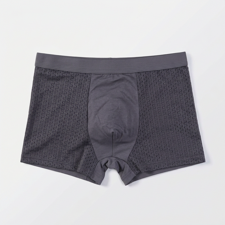 Grijze boxershort plat neergelegd, met effen middenpaneel en gaatjesstof aan de zijkanten 4