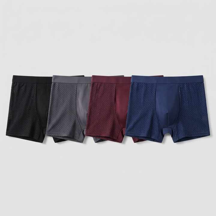 Vier boxershorts naast elkaar in zwart, grijs, bordeauxrood en marineblauw, met geperforeerde zijpanelen 3