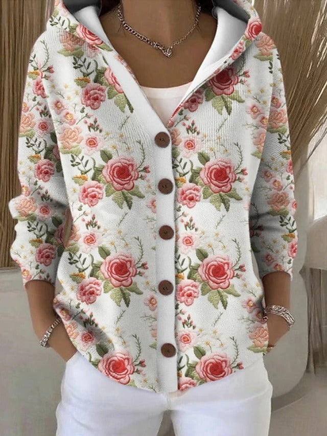 Gedragen door een model: witte hoodie met knopen en een print van roze rozen met groene blaadjes. 5