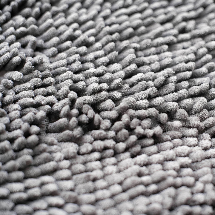 Close-up van de dikke, zachte grijze chenille vezels van de deurmat. 7