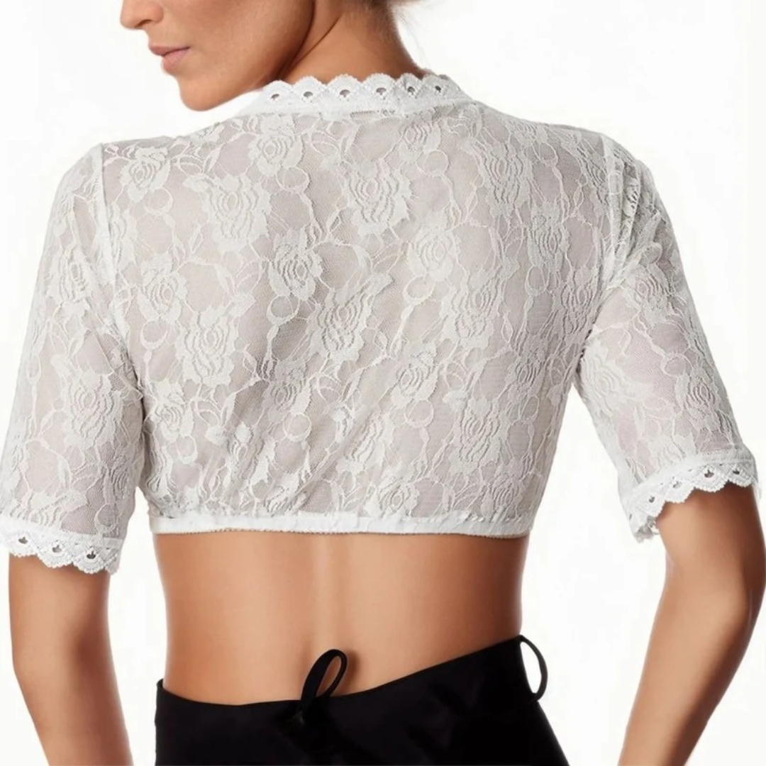 Achterkant van het witte kanten crop top gedragen door een model, met doorschijnend rozenkant, schulprand aan de nek en op de mouwen. 2
