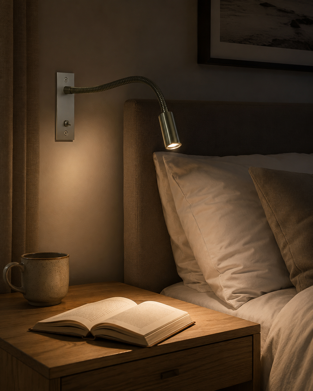 Lamp in zilverkleurige afwerking brandt boven een bed in schemerlicht en verlicht een opengeslagen boek op het nachtkastje. 8