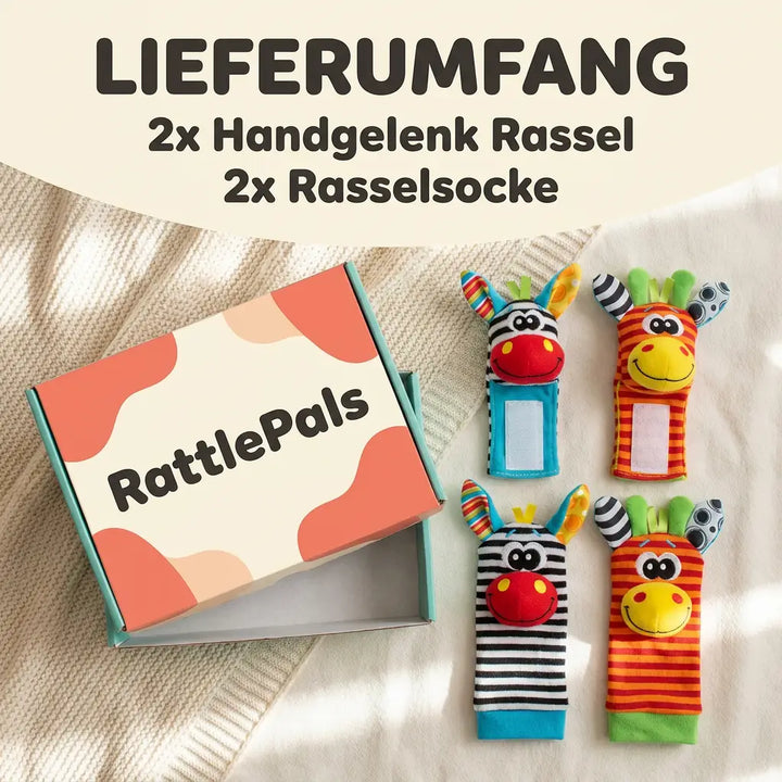 Complete set van twee polsrammelaars en twee rammelsokken naast een geopende kartonnen doos op een crèmekleurige deken. 6