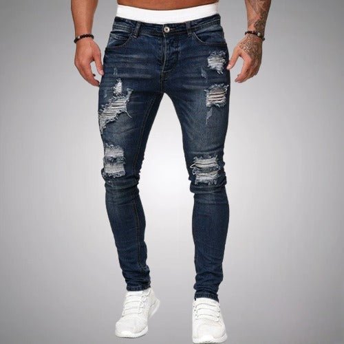Voorkant van donkerblauwe slim fit jeans met scheuren bij dijen en knieën, gedragen met witte sneakers. 4
