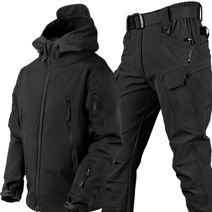 Zwarte jas met capuchon, ritszakken en mouwzakken naast bijpassende zwarte broek met riem en cargozakken, samen getoond als set 21